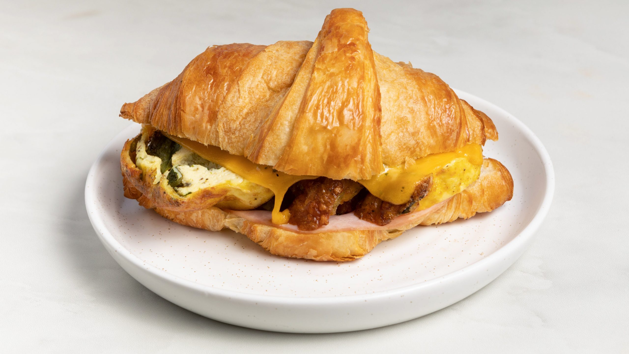 AM AND CHEDDAR EGG CROISSANT.
